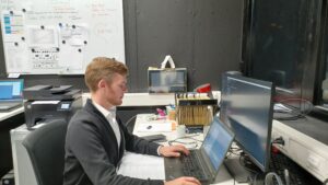 man working at laptop in working surrounding